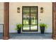 Inviting front entrance featuring a black metal door, decorative lights, and manicured plants at 819 Loridans Dr, Atlanta, GA 30342
