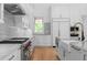 Stunning kitchen with white cabinets, marble countertops, high-end appliances, and hardwood floors at 819 Loridans Dr, Atlanta, GA 30342