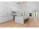 Bright, modern kitchen with white cabinets, an island with barstool seating, and stainless steel appliances at 819 Loridans Dr, Atlanta, GA 30342