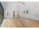 Living room features hardwood floors and an abundance of natural light from large windows and glass doors at 819 Loridans Dr, Atlanta, GA 30342