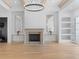 Elegant living room featuring a fireplace, wood beams, chandelier, and light wood floors at 819 Loridans Dr, Atlanta, GA 30342