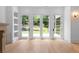 Bright living room with hardwood floors, built-in shelving and doors leading to the backyard at 819 Loridans Dr, Atlanta, GA 30342