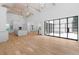 Spacious living room featuring an open layout, wood beams, hardwood floors, and a modern kitchen at 819 Loridans Dr, Atlanta, GA 30342