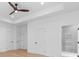 Spacious primary bedroom features tray ceiling, fan, hardwood floors, and an ensuite bathroom with glass shower at 819 Loridans Dr, Atlanta, GA 30342