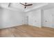 Large main bedroom features hardwood floors, a ceiling fan, a tray ceiling, and several closets at 819 Loridans Dr, Atlanta, GA 30342