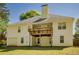 Two-story home with a deck, lawn and garage door at 160 Vinnys Way, Covington, GA 30014