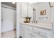 Bright bathroom featuring a large mirror, white cabinets, and a shower with curtain at 2556 Oakwood Se Trce, Smyrna, GA 30080