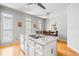 Bright kitchen featuring an island with a granite countertop and stainless steel sink, plus a breakfast nook with table at 2556 Oakwood Se Trce, Smyrna, GA 30080