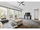 Living room with large windows, neutral colors, and a ceiling fan at 2556 Oakwood Se Trce, Smyrna, GA 30080