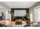 Well appointed living room featuring a large screen, plush seating, and modern lighting at 2556 Oakwood Se Trce, Smyrna, GA 30080