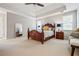 Spacious main bedroom suite featuring a large carved wooden bed, neutral carpet, and decorative lighting at 2556 Oakwood Se Trce, Smyrna, GA 30080