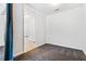 A minimalist room with carpet and doorway leading into a brighter tiled area at 2556 Oakwood Se Trce, Smyrna, GA 30080