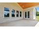 Covered brick porch featuring a wood paneled ceiling, multiple windows, and french doors at 3284 Hall Rd, Dacula, GA 30019