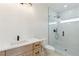 Bright bathroom featuring white countertop sink and glass shower with pebble tile floor at 3284 Hall Rd, Dacula, GA 30019