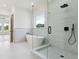 Modern bathroom featuring a soaking tub, glass enclosed shower, and stylish fixtures at 3284 Hall Rd, Dacula, GA 30019