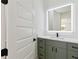 Well-lit bathroom featuring a vanity with a modern mirror, countertop, and stylish cabinet hardware at 3284 Hall Rd, Dacula, GA 30019