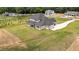 Newly constructed two-story home with a modern design, a long driveway and pristine lawn at 3284 Hall Rd, Dacula, GA 30019