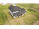 Rear aerial view highlighting the covered patio and backyard of a modern two-story home with a green lawn at 3284 Hall Rd, Dacula, GA 30019