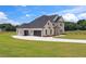 Modern two-story home with a three-car garage and well-maintained lawn at 3284 Hall Rd, Dacula, GA 30019