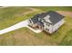 New two-story home features a modern aesthetic, a long driveway, and a well-manicured lawn at 3284 Hall Rd, Dacula, GA 30019