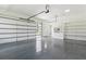 Bright and organized garage space with an epoxy floor, storage shelves, and a glass panel door at 3284 Hall Rd, Dacula, GA 30019