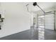 Clean, modern garage with epoxy floors, a glass panel garage door and an automatic door opener at 3284 Hall Rd, Dacula, GA 30019