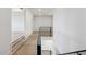 Bright hallway with modern black railing and light hardwood floors connects living spaces at 3284 Hall Rd, Dacula, GA 30019
