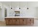 Large kitchen island with room for seating, custom cabinets, and modern appliances at 3284 Hall Rd, Dacula, GA 30019