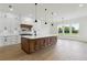 Spacious kitchen featuring a large island, custom cabinetry, and stainless steel appliances at 3284 Hall Rd, Dacula, GA 30019