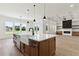 Open kitchen featuring a large kitchen island with a farmhouse sink and stainless steel appliances at 3284 Hall Rd, Dacula, GA 30019