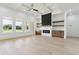 Bright living room featuring a fireplace with marble surround, wood shelving, and expansive windows offering scenic views at 3284 Hall Rd, Dacula, GA 30019