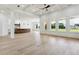 Expansive living area with large windows, coffered ceilings, and view of the kitchen and outdoor surroundings at 3284 Hall Rd, Dacula, GA 30019