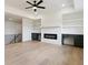 Spacious living room with fireplace, built-in shelves, and sleek hardwood floors at 3284 Hall Rd, Dacula, GA 30019
