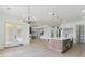 Open concept living and kitchen area with hardwood floors, kitchen island and dining room at 3284 Hall Rd, Dacula, GA 30019