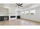Living room with hardwood floors, a fireplace, built-in shelves and cabinets, and ceiling fan at 3284 Hall Rd, Dacula, GA 30019