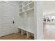 A mudroom with built-in storage, bench seating, and convenient access to both the front door and kitchen area at 3284 Hall Rd, Dacula, GA 30019