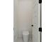 Compact powder room with modern toilet, door and fixtures at 3284 Hall Rd, Dacula, GA 30019