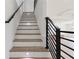 Staircase with oak treads, white risers and modern black railing at 3284 Hall Rd, Dacula, GA 30019