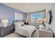 This stylish bedroom has a large window providing natural light and a view of the neighborhood at 82 Sheryl Way, Loganville, GA 30052