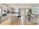 Bright kitchen featuring stainless steel appliances, white countertops, a kitchen island with barstool seating, and hardwood floors at 82 Sheryl Way, Loganville, GA 30052