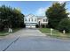 Two-story home with two-car garage, stone facade, and landscaped front yard at 1047 Martin Heights Dr, Lawrenceville, GA 30044