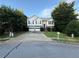 Two-story home with two-car garage, stone facade, and landscaped front yard at 1047 Martin Heights Dr, Lawrenceville, GA 30044