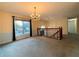 Spacious living room featuring a chandelier, large window, and view of the stairway at 1047 Martin Heights Dr, Lawrenceville, GA 30044