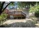 View of the backyard with an elevated deck and covered space at 6403 Charter Way, Lithonia, GA 30058