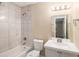 Well-lit bathroom featuring a tiled shower and modern fixtures at 6403 Charter Way, Lithonia, GA 30058
