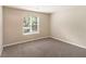 Bright bedroom with a window and plush carpeting provides a comfortable living space at 6403 Charter Way, Lithonia, GA 30058