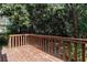 Backyard view of weathered wooden deck surrounded by lush greenery at 6403 Charter Way, Lithonia, GA 30058