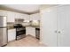 Well-lit kitchen featuring stainless steel appliances and granite countertops at 6403 Charter Way, Lithonia, GA 30058
