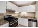 Well-lit kitchen featuring stainless steel appliances and granite countertops at 6403 Charter Way, Lithonia, GA 30058