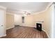 Bright living room featuring a cozy fireplace, modern ceiling fan and wood flooring at 6403 Charter Way, Lithonia, GA 30058